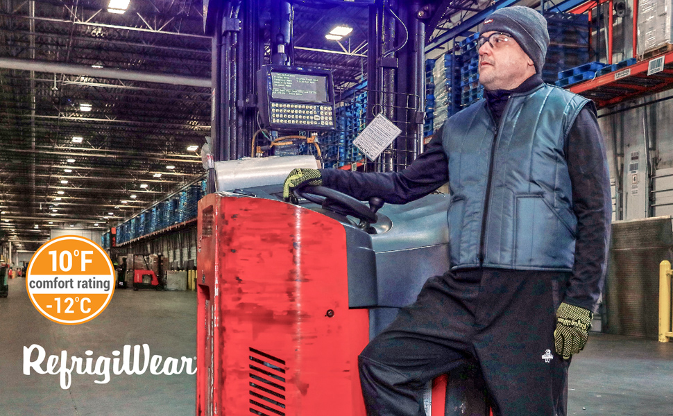 Man standing next to a forklift in a cold storage facility wearing a Cooler Wear Vest