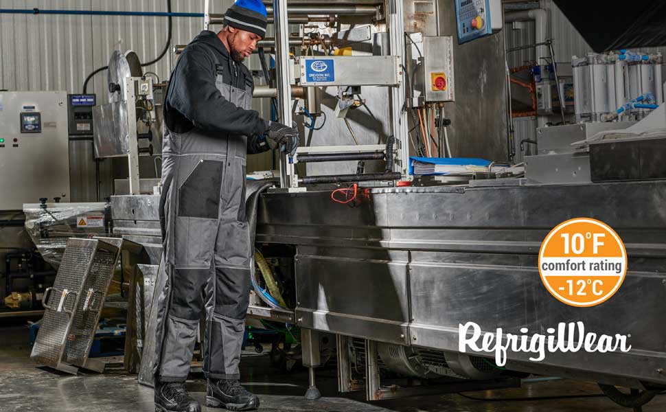Man in cold factory wearing RefrigiWear ChillShiled Insulated Bib Overalls